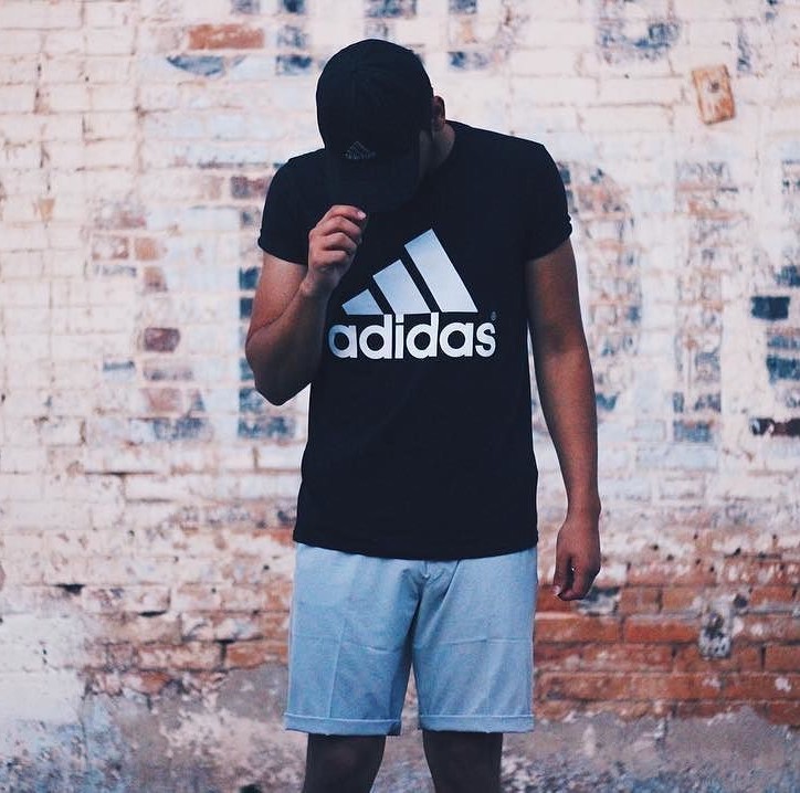 man in adidas shirt and shorts