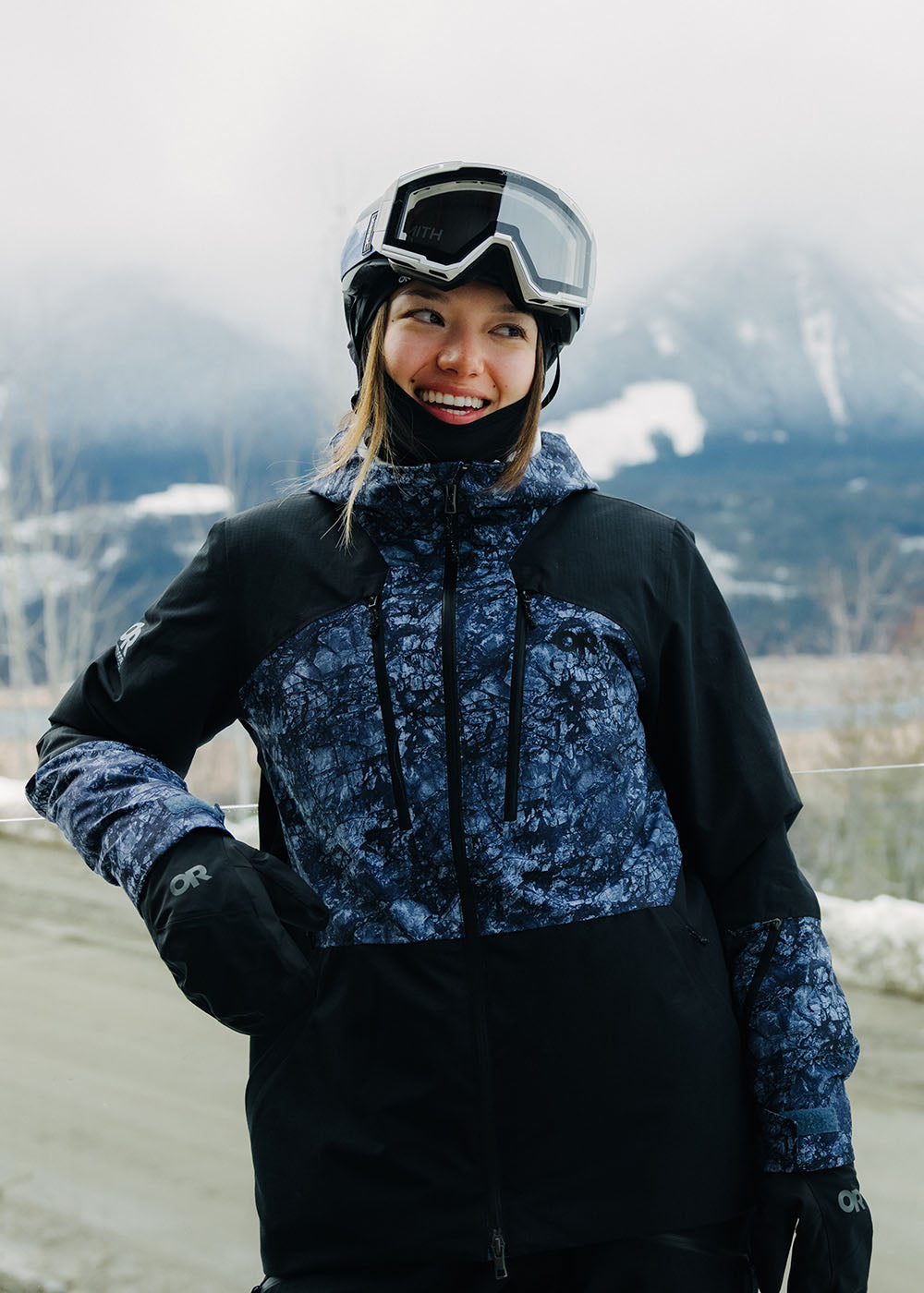 Person in winter clothing with a mountainous background.